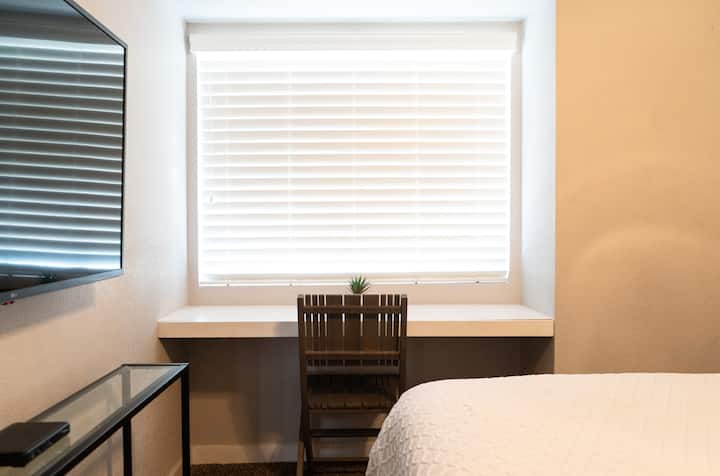 Guest bedroom #3 with Queen bed and large closet.  Also has wall mounted TV and work station.