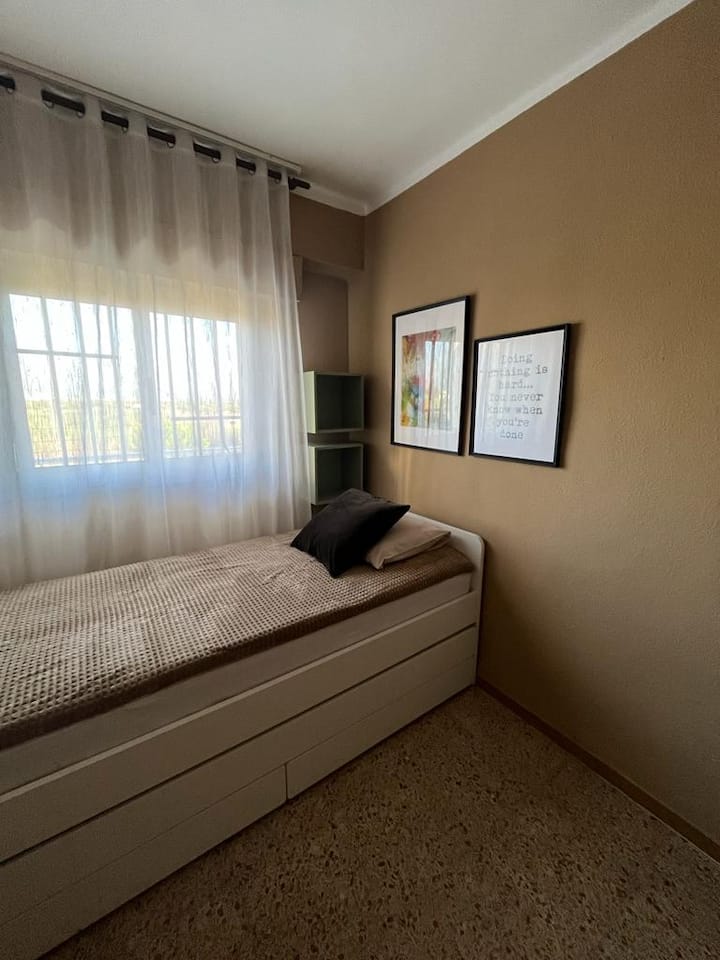 Chambre avec un lit simple avec un lit gigogne et des tiroirs en dessous