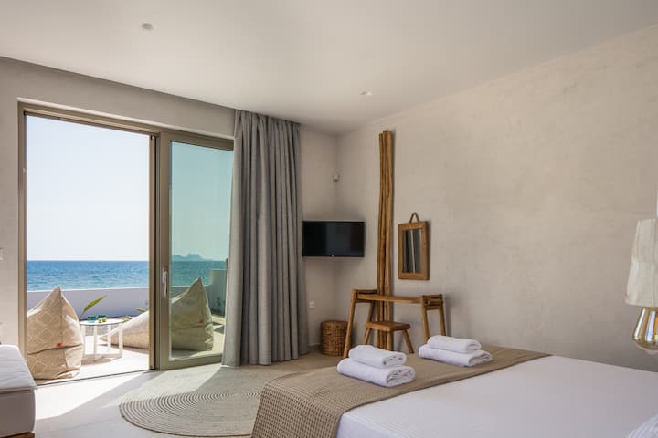 The sand & pebble beach can easily be reached through a door at the front of the Villa