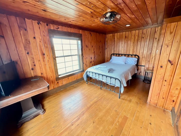 Bedroom 1 sits off living room and offers a TV, spacious closet, ceiling fan/light, lots of natural light, and window blinds for extra privacy. 