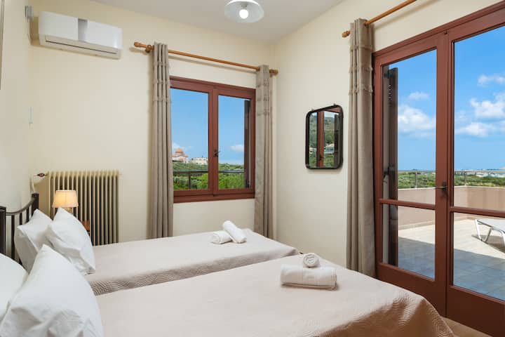 Bedroom 4, balcony door, window, two single beds.