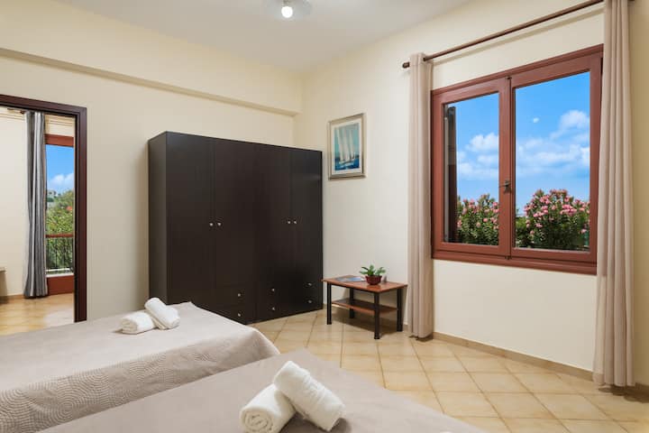 Bedroom 1, window, double bed and single bed.