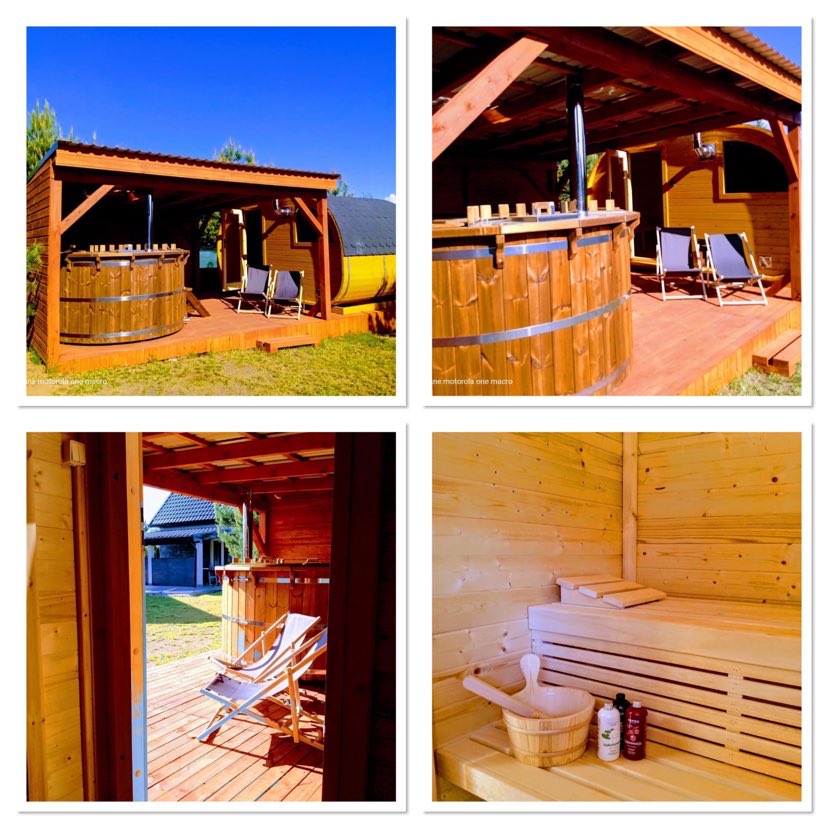 A wooden hot tub is situated on a deck beneath a covered structure, complemented by two lounge chairs. The sauna is visible with natural wood paneling, featuring a wooden bench, a bucket, and bottles on a shelf. Sunlight filters through the open doorway.