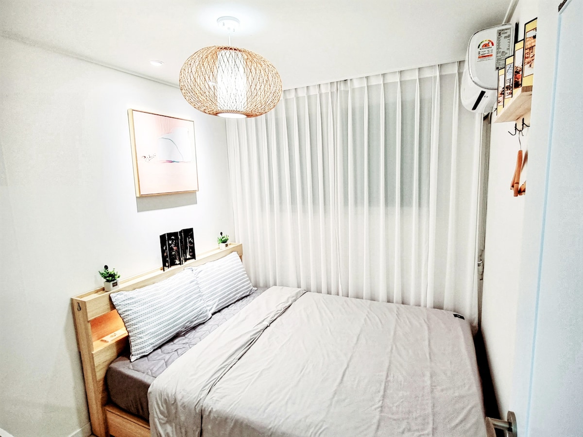 Bedroom B:
- Queen sized bed 
- Air conditioner 
- Working space or dresser 
- hair dryer