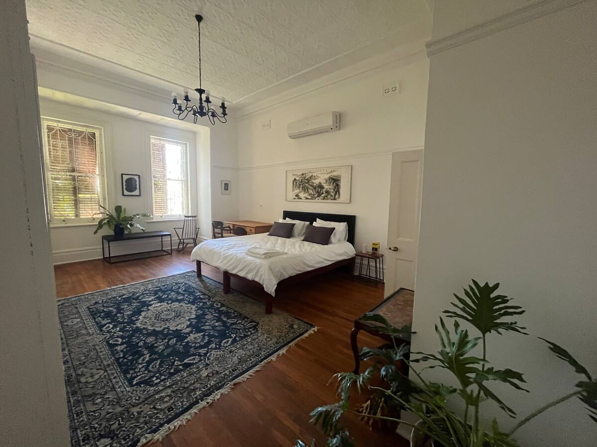 King bed and wooden floors in the king en-suite room at Utopia Cape Town