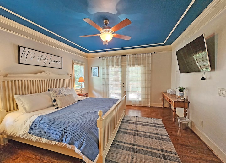 Main level king bedroom with en suite full bath. Soak in the sunrise with French doors to the deck and views of the lake.
