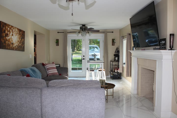 Living room.  Comfy sectional couch area with 65" Roku enabled television. Fiber internet with clear WIFI in every area within the house.  