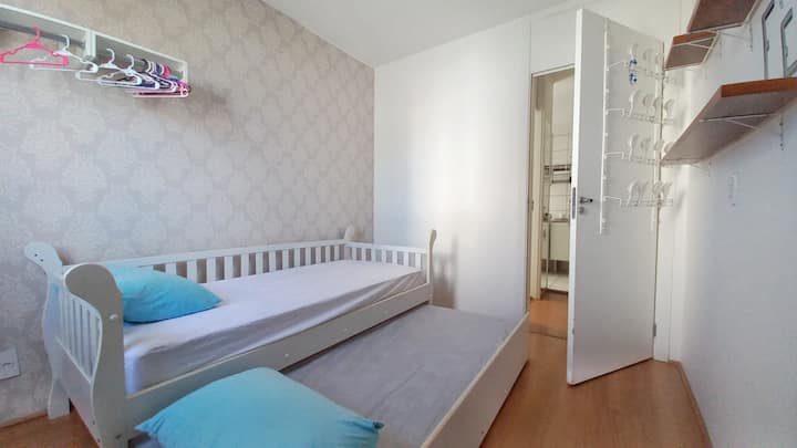 Bedroom II with twin bed, hangers. Note: The bed could also be used as a crib for those with small children.