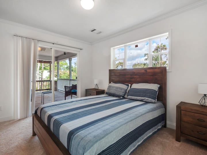 Bedroom 1 with ensuite bathroom and access to back porch