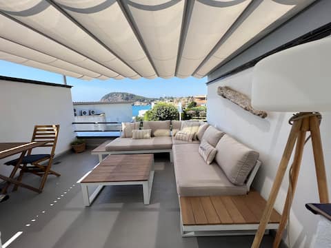 Terraces, design, and tranquility facing the sea.