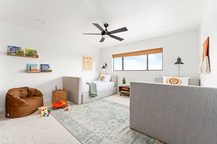 Twin beds with toys and books, beds have trundles and can sleep a total of 4 people.