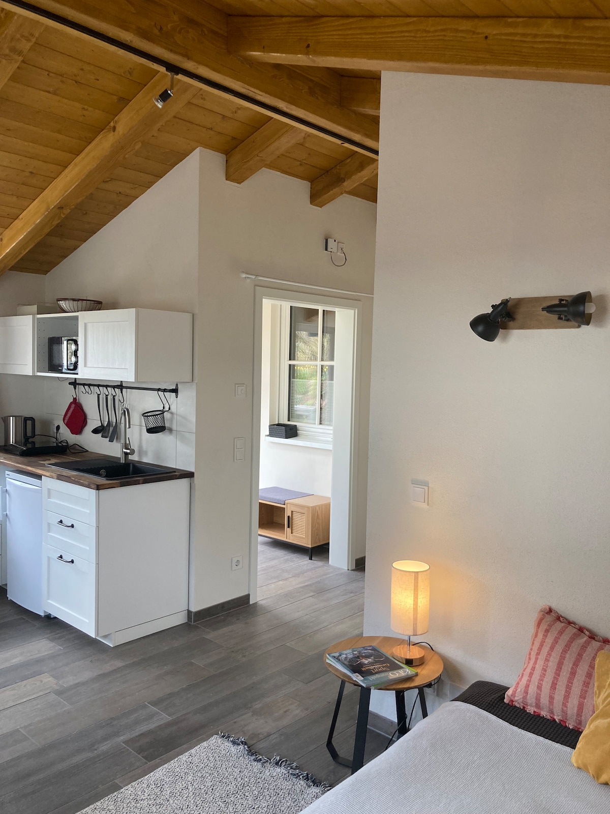 Blick vom Schlafsofa/Bett aus in Richtung Küchenzeile und Eingangsbereich 