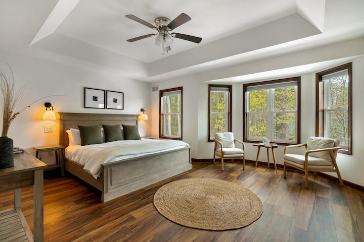 غرفة رئيسية بسرير كبير وإضاءة بجانب السرير القابلة للتعتيم