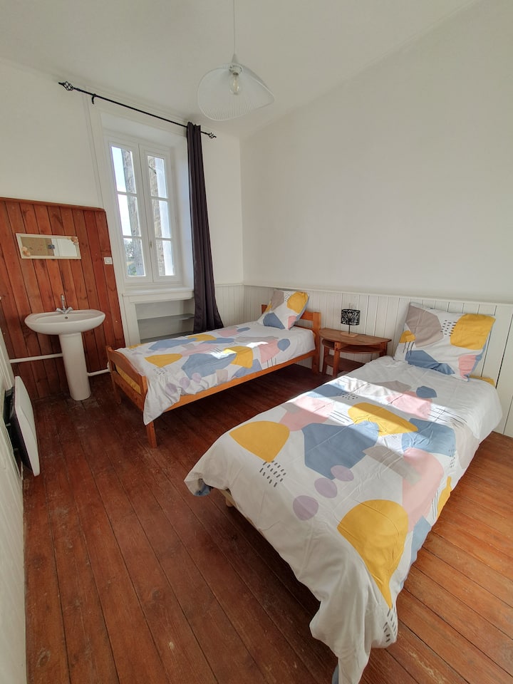 Bedroom with 2 single beds, small storage shelves.
shutter + blackout curtain
