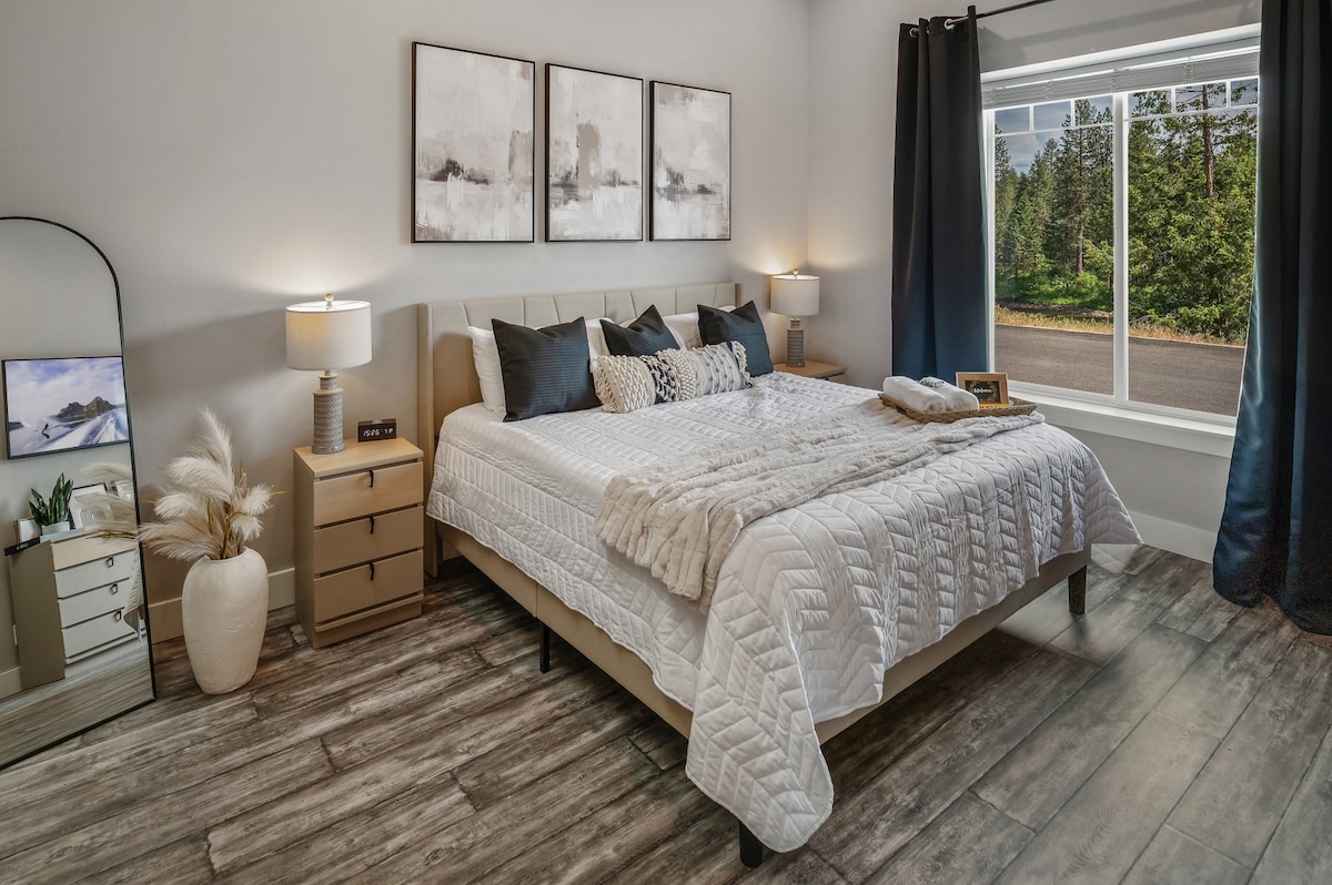 Master bedroom w/ king bed and view of the river