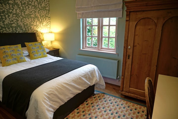 Master bedroom with a double bed and kingsize duvet.