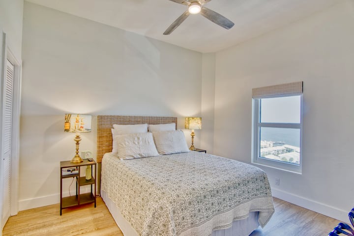 This retro, cozy bedroom with a queen size bed has stunning views of the sound and the Navarre water tower.