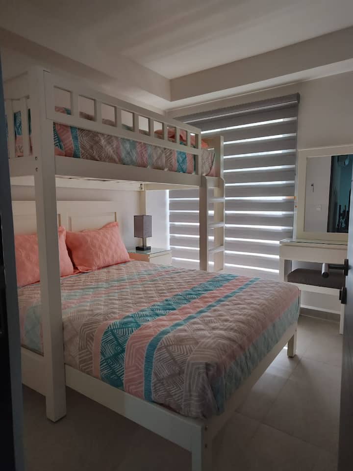 Bunk bed with a queen size bed and a twin bed.
