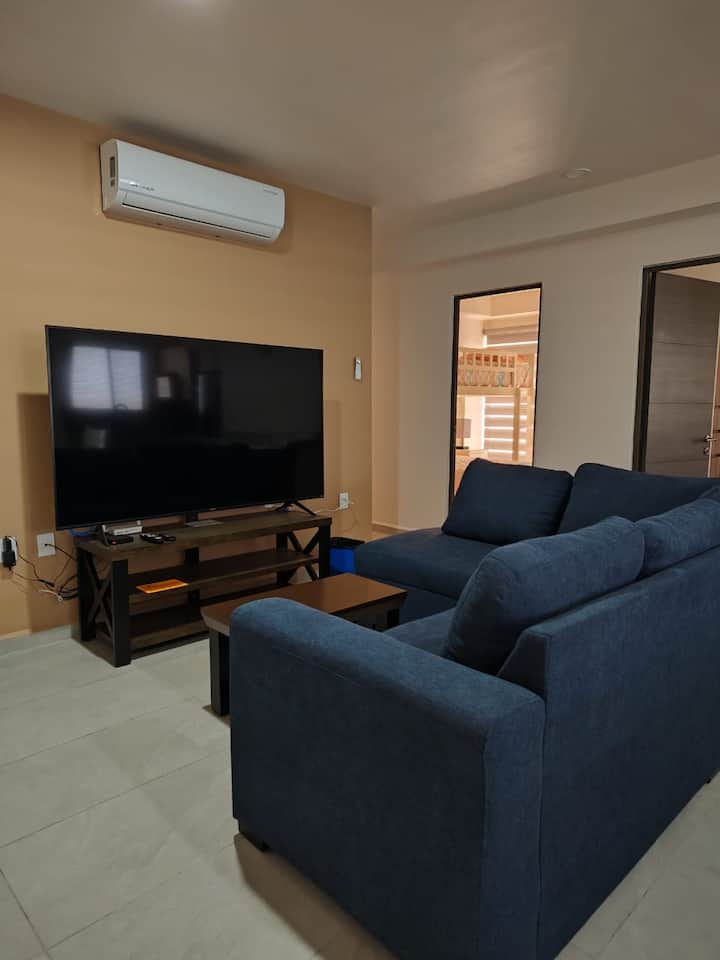 Living room with 70 inch smart TV screen.