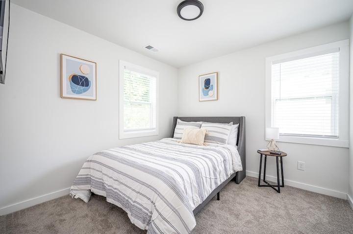 Bedroom with a queen size bed and smart tv. 