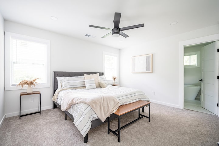 Primary suite with a king size bed and a full spa-like bathroom