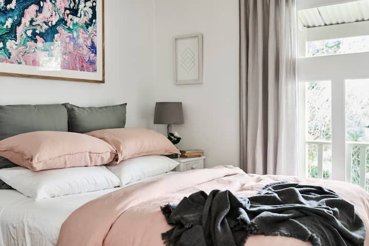 The Queen-sized second bedroom has a wonderful view to the balcony and into the garden. See if you can spot the bowerbird in the tree just outside.