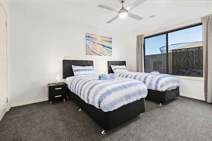 Two long singles that can be converted to a king size bed, ceiling fan, and block out curtains.
