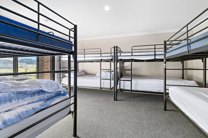 Bedroom 1 has four king single bunk beds.  
Underneath the bunk beds are stored two raisable single trundle beds. One can be set up in the bunk room, and one can be set up in the  master bedroom if required.