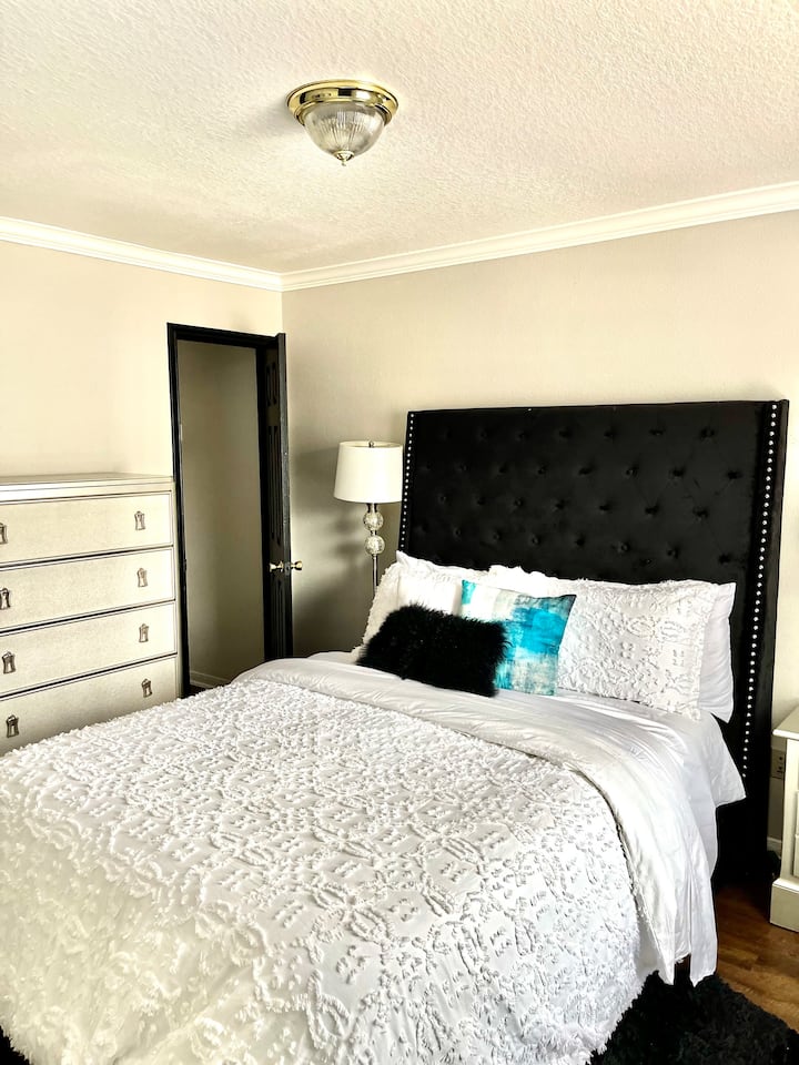 Downstairs bedroom with flat screen smart TV and luxury linens. 