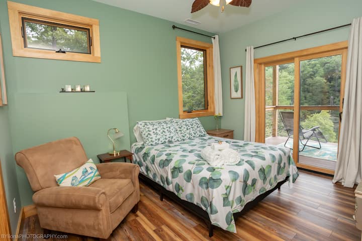 Wake up to the sun rise looking out at the lake. Main bedroom with a view of the deck and lake. 