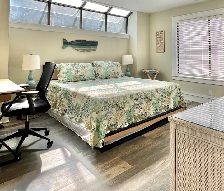 The first-floor King bedroom takes in natural light through the transom window
