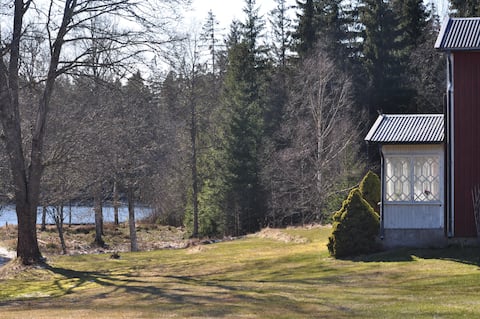 Spacious house surrounded by forest, fields and water