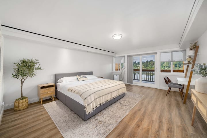 Hoofdslaapkamer met kingsize bed, balkon en uitzicht op het meer