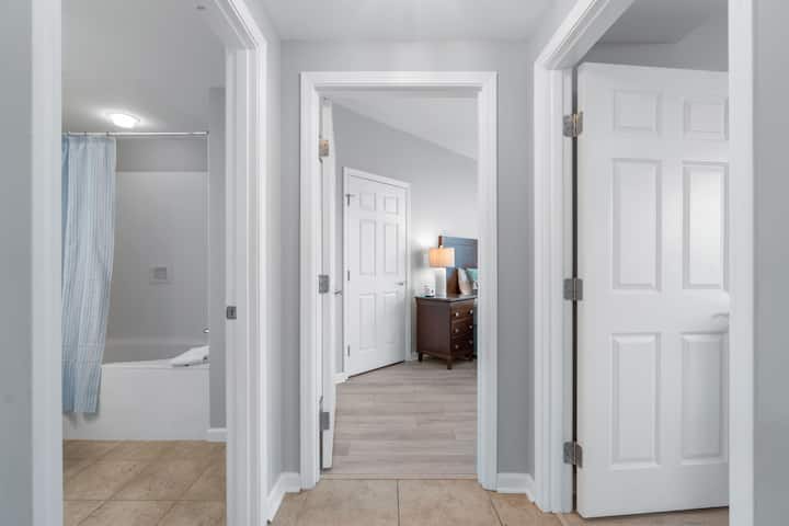 Hallway looking into 2nd King bedroom, 3rd bedroom on the right and Guest bathroom on the left.