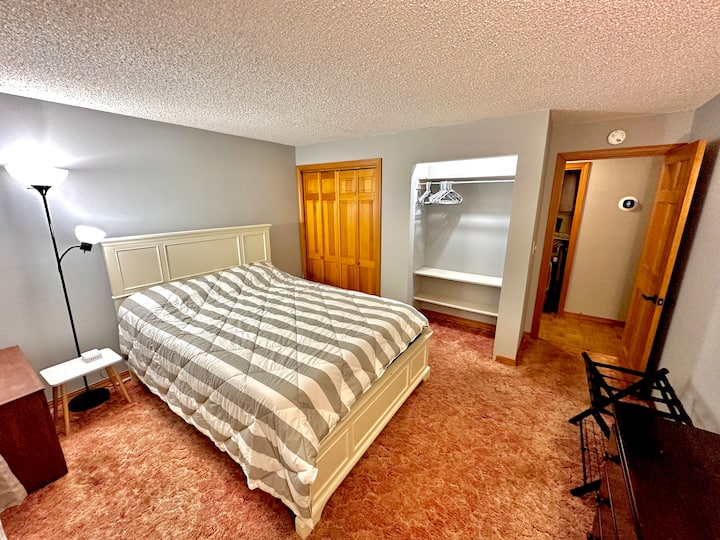 First floor bedroom with queen bed and plenty of storage