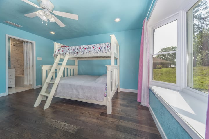 The house has been in the host's possession for many years and this bay window was a part of the latest remodel. This is an amazing guest bedroom facing the front of the house, featuring a bunk bed, closet and full guest bath. 
