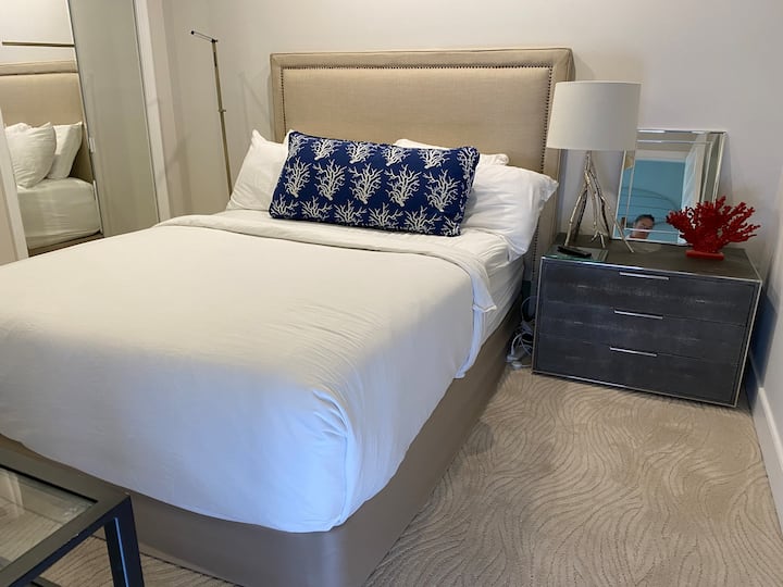 მე-2 სართულის სტუმრების საძინებელი 152 × 203 სმ სიმაღლის საწოლი სააბაზანოთი საშხაპით.  Თეთრი პირსახოცები, მუქი სარეცხი ტილო, ენათმეცნიერული აბაზანა - საპონი და შამპუნი