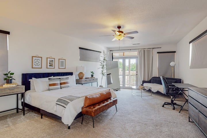 The second master suite located upstairs makes for the final fourth bedroom. A private balcony with some seating over looking the backyard. A king-sized bed with a desk, black-out curtains, and its own wet bar with mini fridge. Massive bathroom.