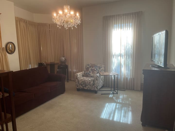 Living room with sofa bed.
Please do NOT open the original blown curved glass windows in the corner. 