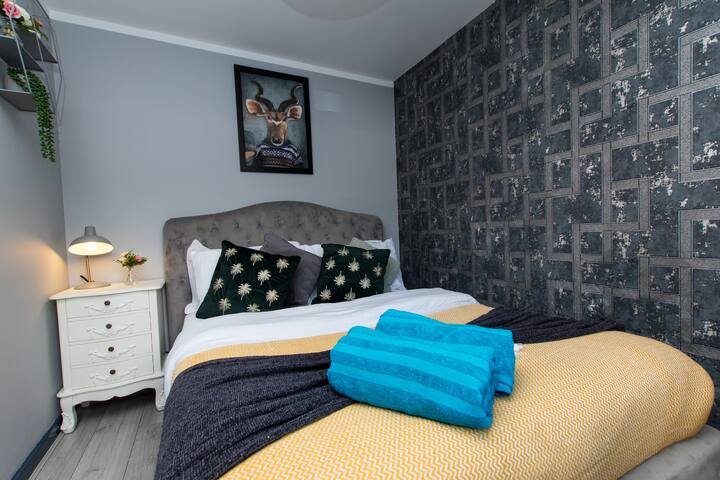 Disfruta de la comodidad en nuestro espacioso dormitorio con una lujosa cama tamaño king. Las sábanas suaves y una decoración elegante crean un ambiente sereno. Despiértate renovado y rejuvenecido en este tranquilo refugio, listo para explorar y disfrutar de tu estancia.