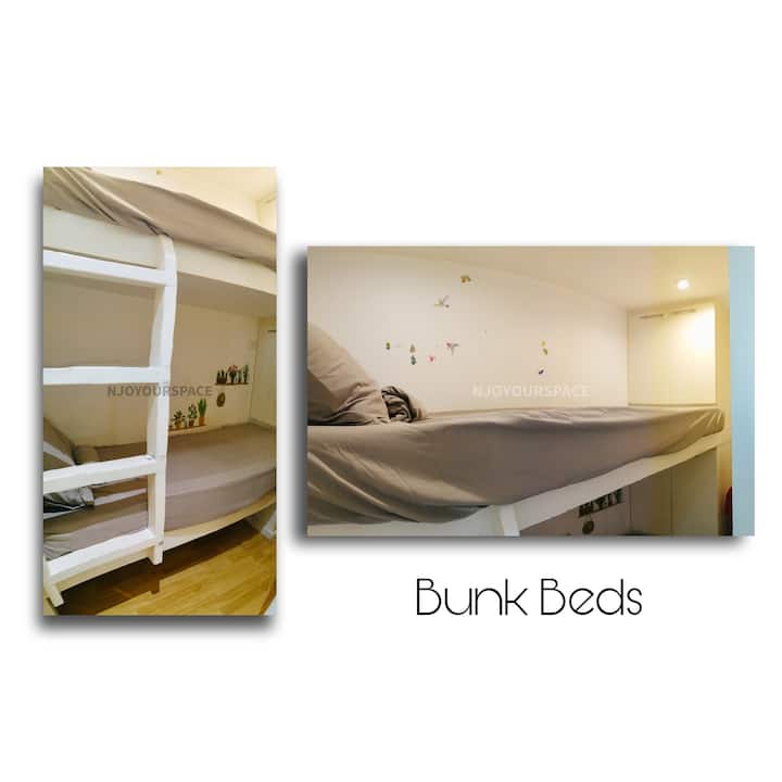 The extra small room with bunk beds and dresser. The bed size here is smaller than a single bed, but can still fit an adult. The room only has dim yellow light. Fan is available for the room.