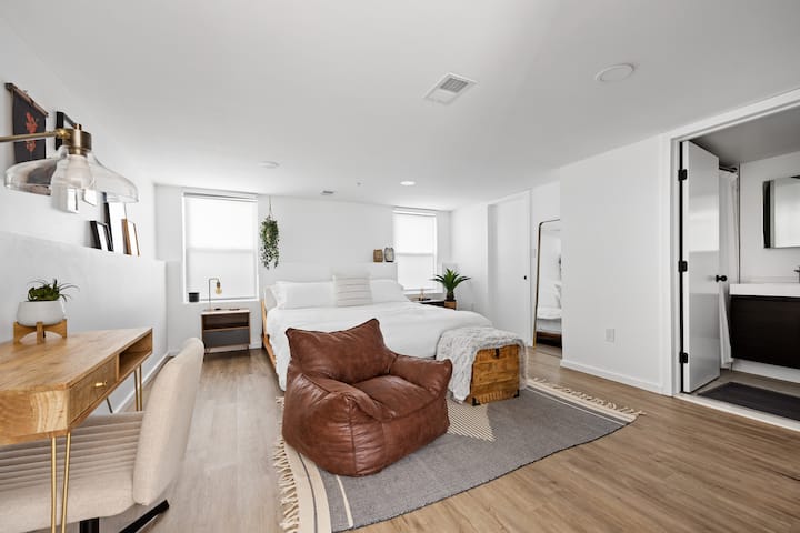 主卧配有电视、办公桌、套房浴室和步入式衣柜