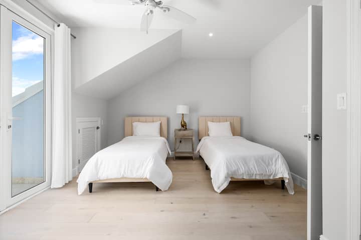 Bedroom 4 with 2 single beds and a private balcony. 

Note: The twin beds can be converted to one king bed - let us know your preference when booking and we'll have it set up for you arrival.