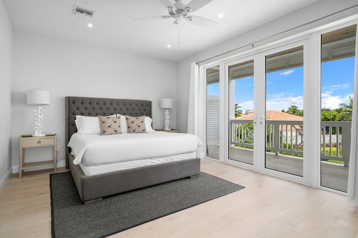 Primary room with king bed, ensuite bathroom and private balcony 