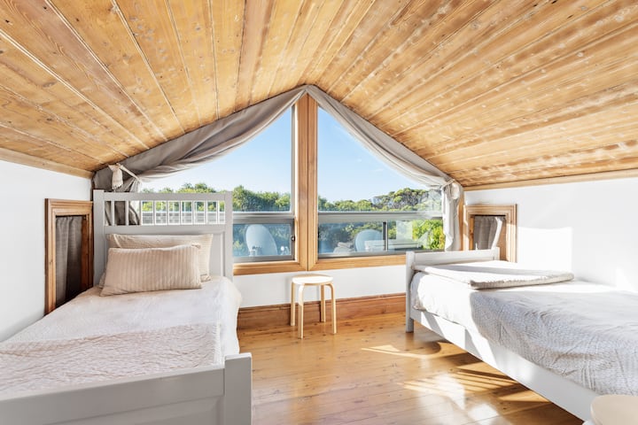 The second bedroom has 2 single beds and a lovely outlook over our back garden.  There are also toys in the storage cubbie for families traveling with kids.