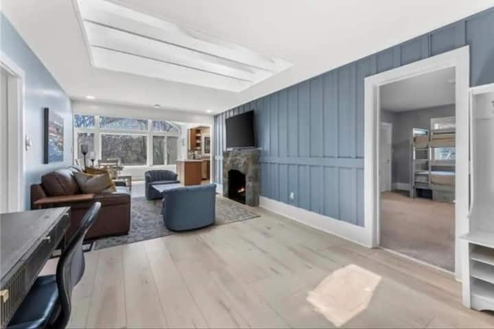 Open living room and dinning room, with a 4K 55 Inch-TV with Disney+NetflixTV and work space. 
