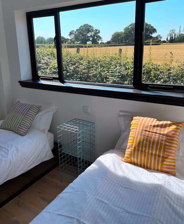 Second bedroom with views across open countryside and our friendly neighbourhood goats! Two single beds complete with Egyptian cotton linen, feather pillows.