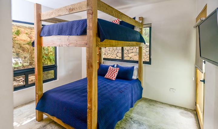 The bunk room contains 2 queen beds, a large built in closet with drawers and a smart tv.  This room also has direct access to the fire pit, which is also accessible from the front of the home.