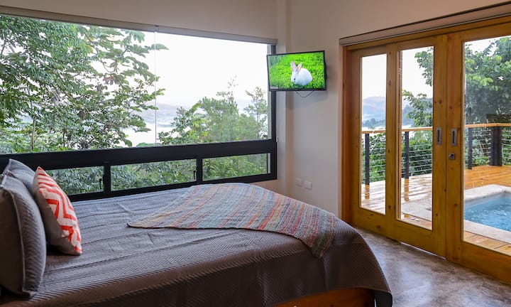 The downstairs master suite includes a queen size bed, built in closet with dresser, a smart tv and a private bathroom.  This room also has sliding doors which gives the guests direct access to the hot tub.
