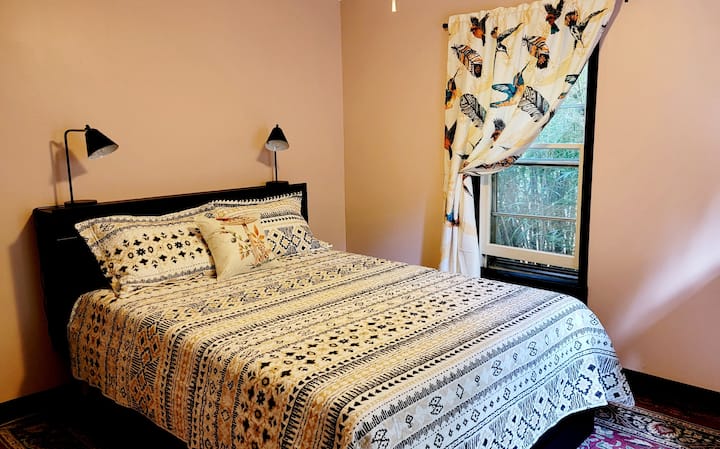 Bedroom, with a comfy, semi-firm Sealy queen memory foam mattress, and built in storage. Lamps feature plug ins and USB ports.